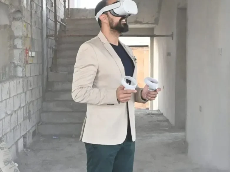 Man wearing virtual reality headset and holding controllers, exploring a construction site for interior design visualization. The image showcases Rady Interiors Virtual Reality technology for immersive 3D interior design experiences.