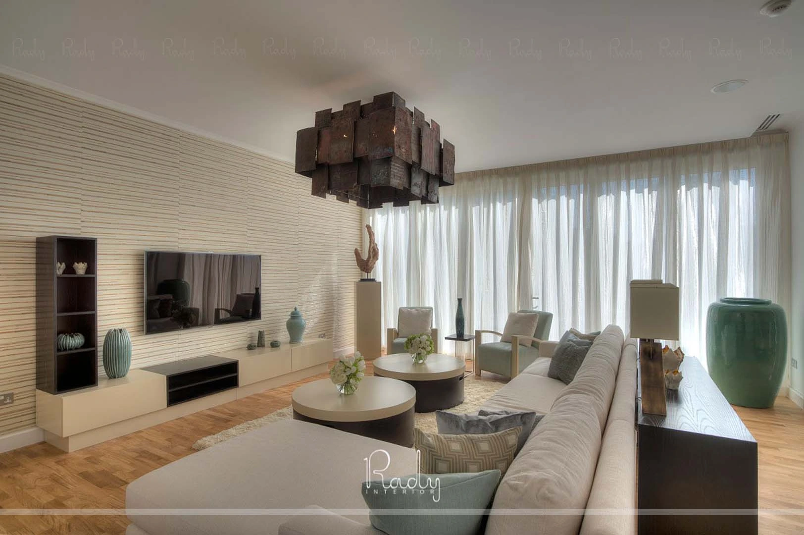 Modern living room featuring a large television, part of a villa renovation in Palm Jumeirah by Rady Interior.